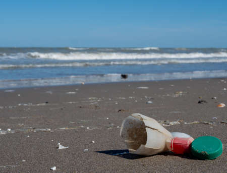 Plastic waste in the sand by the sea