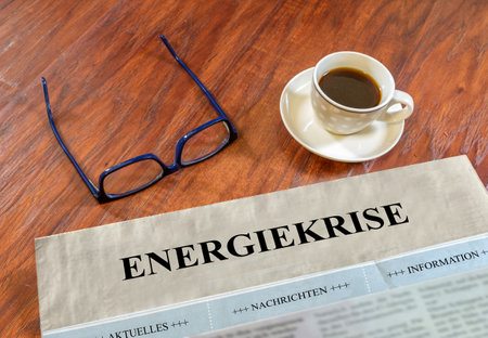 Energy crisis newspaper with glasses and coffee on a deskの写真素材