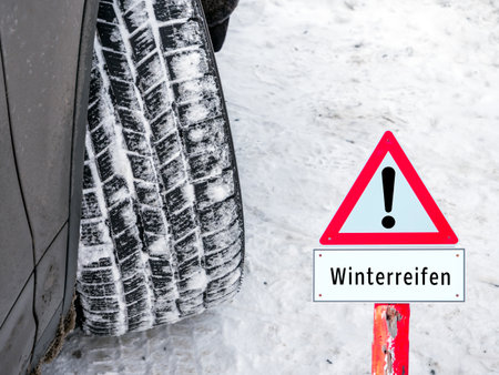 Warning sign for winter tires in winter in Germanの写真素材