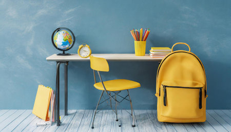 School desk with school accessory and yellow backpack and globe on blue backgroundの素材