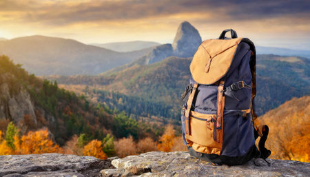 hiking in the mountains with travel backpack on blurred amazing wild nature backgroundの素材