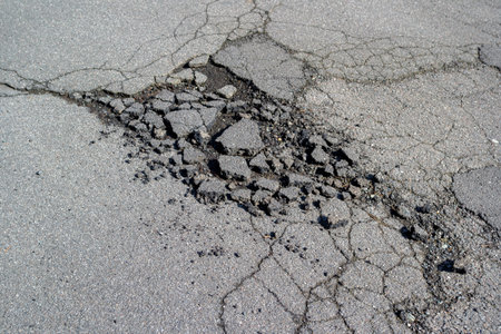 Road damage after frost in winterの写真素材