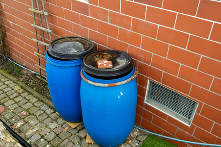 old blue plastic barrel for rainwater in the gardenの写真素材