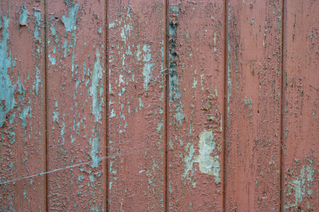 weathered peeling brown paint on a wooden wallの写真素材