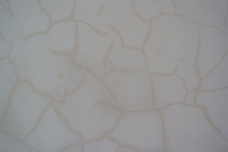 Wall with many cracks in the plaster, structural damageの写真素材