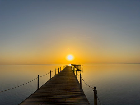 Sunrise on the Red Sea with wooden jetty to the reef, Egyptの写真素材