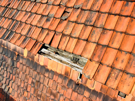 Roof tiles are broken on a house after a storm, severe weatherの写真素材