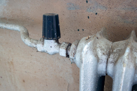 old vintage radiator with valve on the wallの写真素材