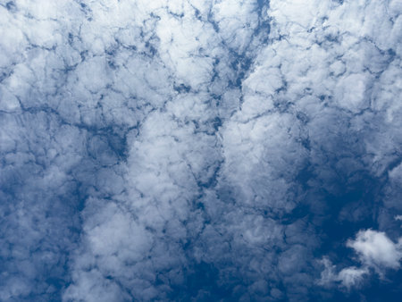 Fleecy Clouds Formation with Blue Sky Texture Backgroundの写真素材