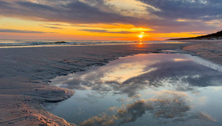 Cloud landscape with sun on a natural beach on the Baltic Seaの写真素材