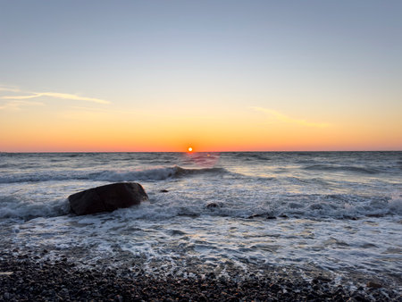 Sunset on the beach with large rocks in the water on the Baltic Sea on RÃ¼genの写真素材