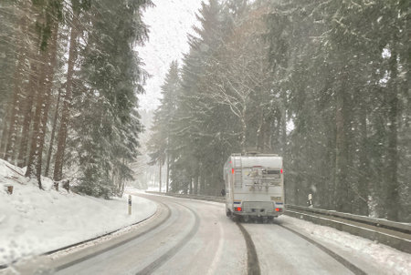 With the motorhome in winter on a winding road in Vogtland, Saxonyの写真素材