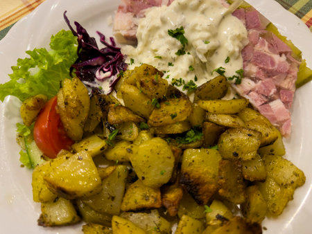 Homemade pork head brown with fried potatoes traditional German foodの写真素材
