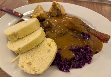 Duck leg with red cabbage and dumplingsの写真素材