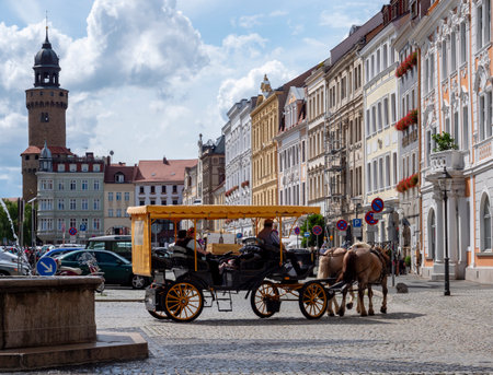 View of the old town of Goerlitz in Saxony with a historic horse-drawn carriageの写真素材