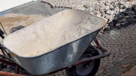 Cobblestones are being laid and renovated in an old town with wheelbarrowの写真素材