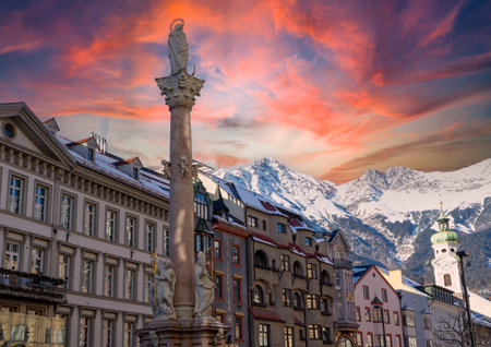 View of the Karwendel mountains with the old town Innsbruck in Austria Tyrol winter snow landscape at sunsetの写真素材
