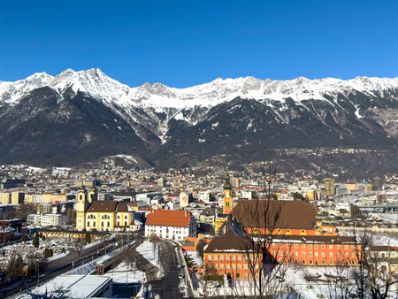 City view of the town Innsbruck in Austria Tyrol with winter landscapeの写真素材