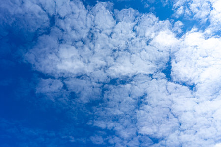 blue sky with cumulus clouds texture backgroundの写真素材