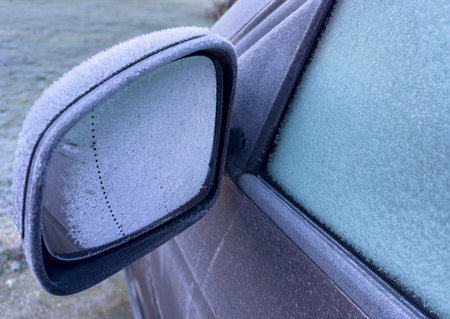 Car mirror in winter in freezing cold with frost in the morningの写真素材