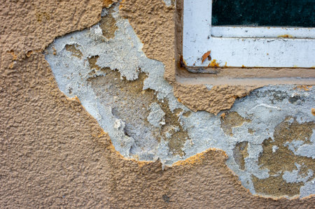old wall with peeling paint and saltpeter under the windowの写真素材