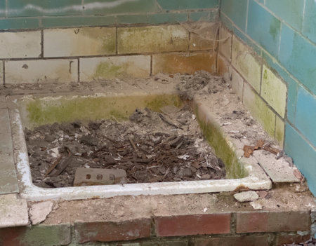 Old shower basin in need of renovation in a bathroomの写真素材
