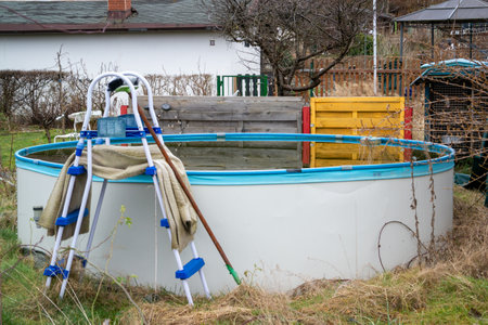 old garden pool with green algae in the waterの写真素材