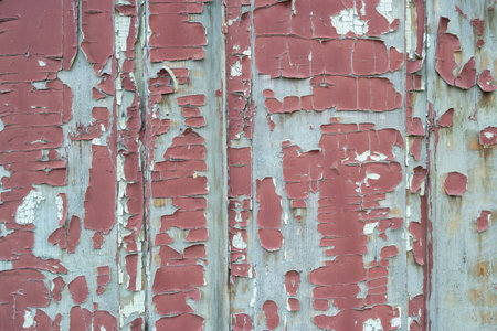 red old peeling wooden paint on a wallの写真素材
