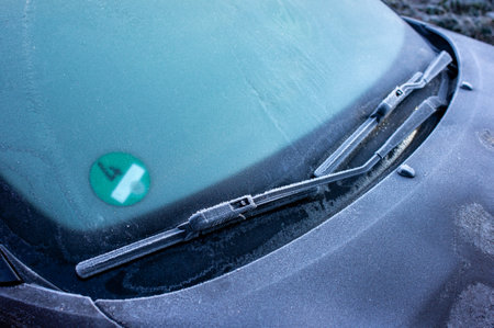Frozen windshield on the car in winter in the icy cold with frost in the morningの写真素材