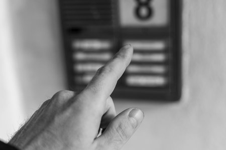 Beware of dubious door-to-door transactions on a doorbell system symbol black and white image