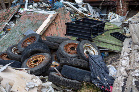 pile of old tires at a recycling center with other scrapの写真素材