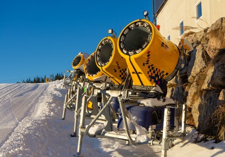 Snow cannons on a ski slope in the Alpsの写真素材