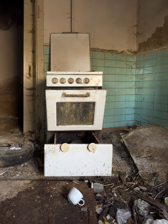Gas stove in the kitchen in an old dilapidated demolished house verticalの写真素材