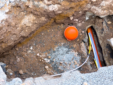 Laying a fiber optic cable for fast internet on the streetの写真素材