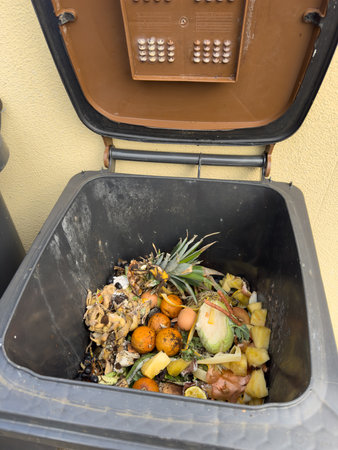 Organic waste and household waste from a brown waste bin verticalの写真素材