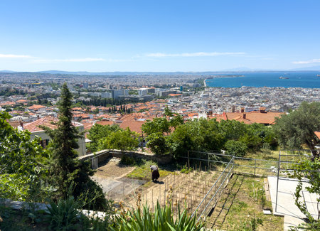View of a garden with a person and the Greek city in the backgroundの写真素材