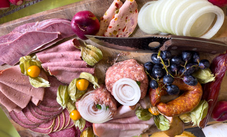 Sausage platter with different types of sausage on a wooden boardの写真素材