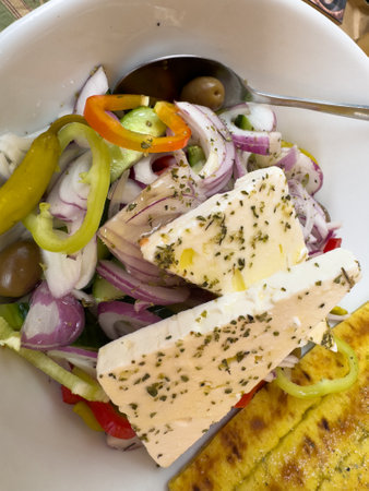 Greek salad with olives, cucumbers, onions and feta cheese verticalの写真素材