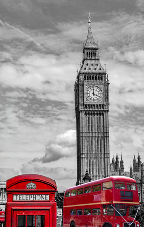 big ben and houses of parliament in London with telephone booth and red double decker bus vertical