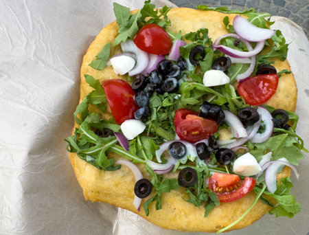 traditional Hungarian lÃ¡ngos with salad with feta cheese, tomatoes and olivesの写真素材
