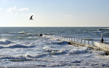 Sea wave splashing against a pier in Odessa. Black Sea.の写真素材