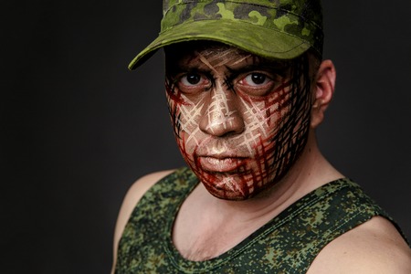 Portrait of Soldier with Military Style Camouflage on a  Face.  Portrait  on black backgroundの写真素材