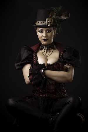 Emotional Portrait of Young Woman in Steampunk or Retro style. Studio shot. Model on a Black Backgroundの写真素材