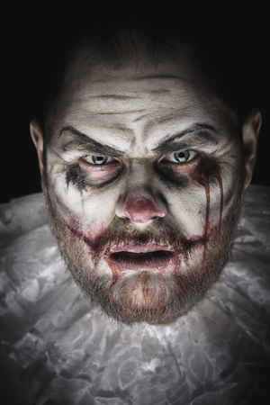 Portrait of a Scary Evil Clown.  Studio shot with horrible face artの写真素材