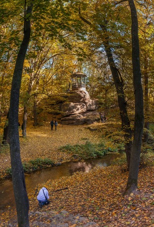 Uman, Ukraine - 10.13.2018. Beautiful autumn trees around the old alcove in Sofiyivka park, Ukraineのeditorial素材