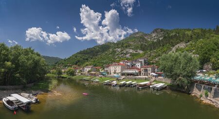 Skadar lake, Montenegro - 07.15.2018.  Panoramic view of the Old Bridge over Crnojevica river, Rijeka Crnojevica, and the tourist area near the bridge, Rijeka Crnojevica.のeditorial素材