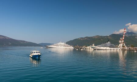 Tivat, Montenegro - 07.11.2018. Embankment of Tivat city, Montenegro, in a sunny summer day. The beginning of the cruise on the Bay of Kotor.のeditorial素材