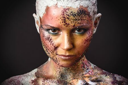 Portrait of Beautiful Young Woman with creative fantasy bird makeupの写真素材