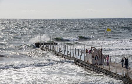 Odessa, Ukraine - 09.05.2019. Stormy sea in the resort of Arcadia in Odessa, Ukraine, on an cloudy autumn day.のeditorial素材