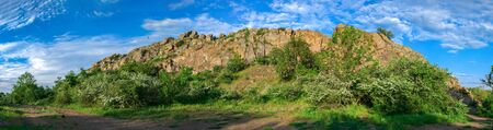 The rocky banks of the Southern Bug River near the village of Migiya in Ukraine on a sunny summer dayの写真素材